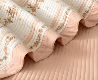 Soft floral bedding set of 3 pieces from The Gharnish, includes quilted bedcover and matching pillow covers on a bed.