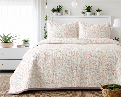 Floral bedding set by The Gharnish featuring a soft quilted bedcover and matching pillow covers in vibrant floral design.