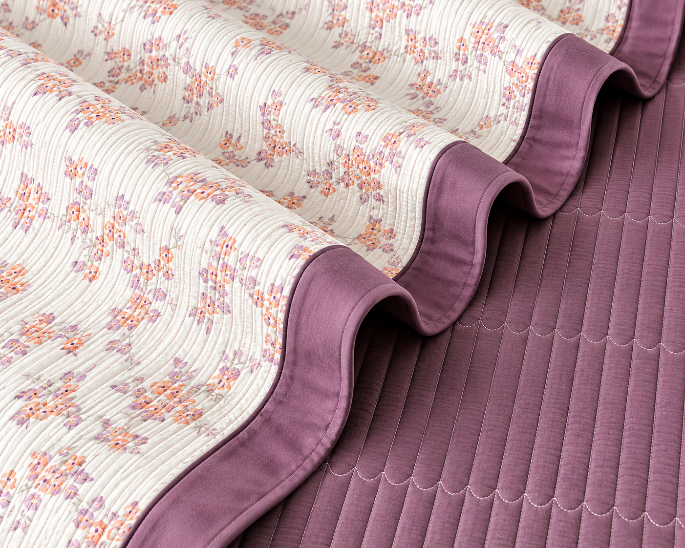 Floral bedding set of 3 pieces by The Gharnish includes a quilted bedcover and matching pillow covers, with a soft, decorative floral pattern.