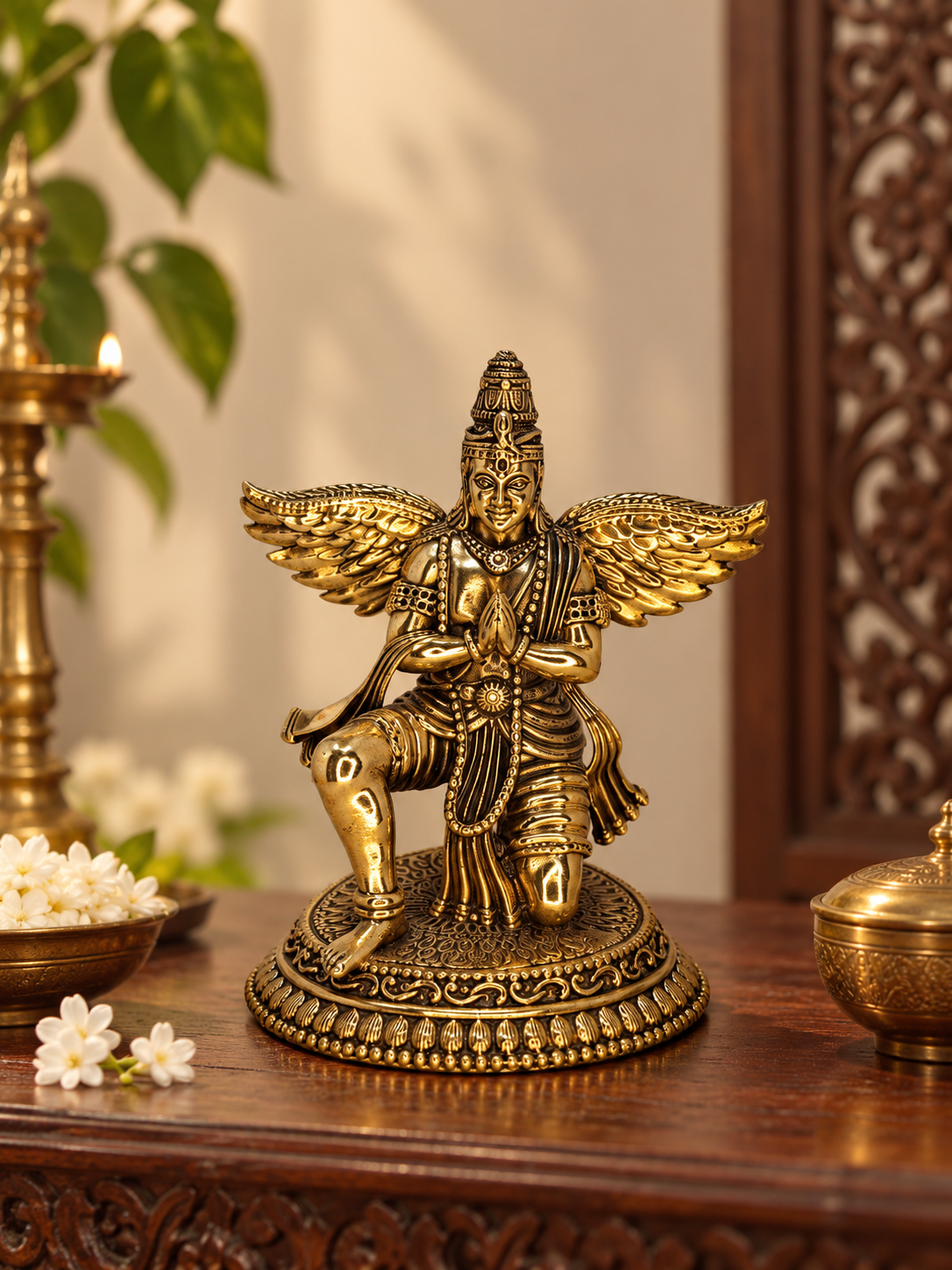 Antique Brass Garuda statue, a traditional brass pooja item with detailed craftsmanship, used in Hindu religious rituals.