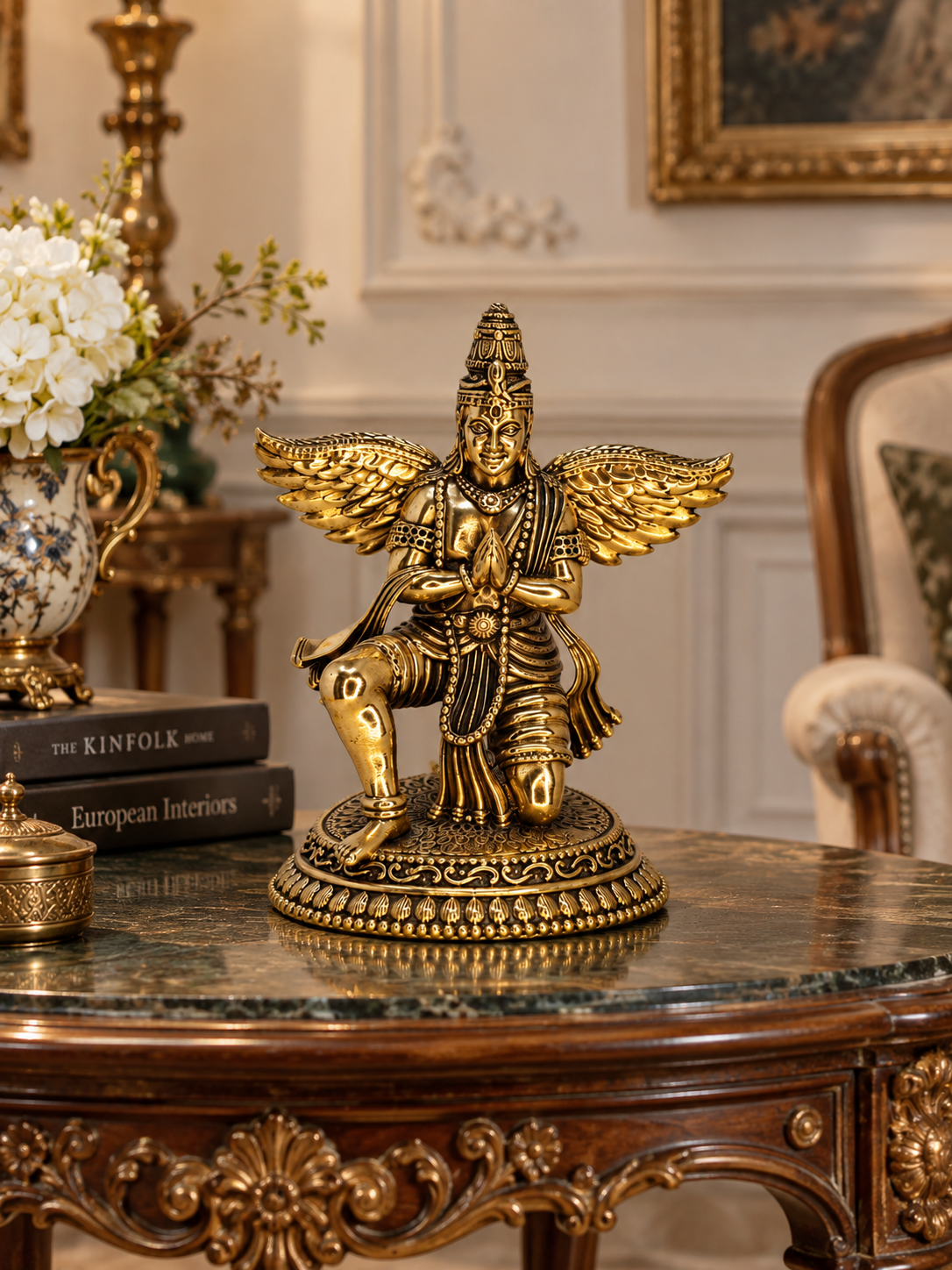 Antique brass Garuda statue, a traditional brass pooja item with intricate detailing, used for religious ceremonies and decor.