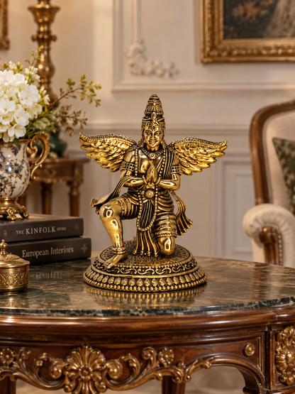 Antique brass Garuda statue, a traditional brass pooja item with intricate detailing, used for religious ceremonies and decor.