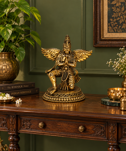Antique brass Garuda statue, a traditional brass pooja item with intricate detailing, used for religious rituals.