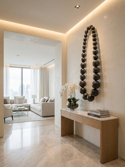 Obsidian bead wall sculpture by The Gharnish, modern wall art featuring glossy black beads arranged in an artistic design.