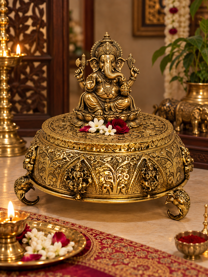 Ornate brass Astalakshmi carved chowki from The Gharnish, decorative puja pedestal with intricate antique brass design.