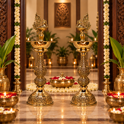 Pair of antique brass peacock deepam traditional pooja lamps by The Gharnish, featuring intricate peacock designs for religious ceremonies.