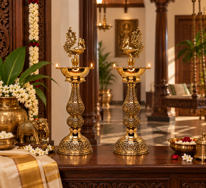 Pair of antique brass peacock deepam lamps, traditional brass pooja items for spiritual rituals and decorative lighting.