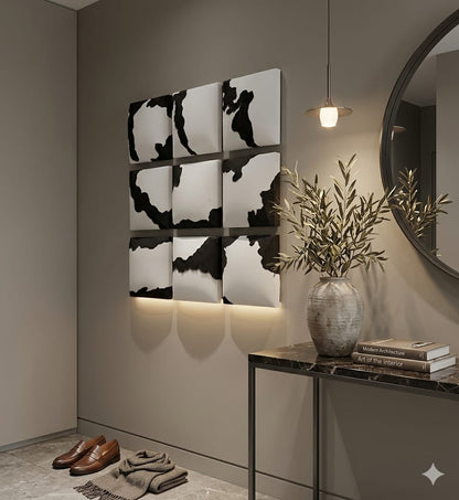 Decorative wall art with black and white patterns in a modern interior setting.