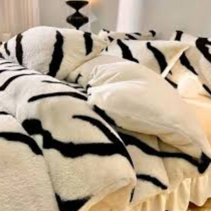 Zebra Print Faux Fur Blanket Set. Crafted with ultra-soft, high-density faux fur, this blanket brings a bold and exotic flair to your space with its striking black and white zebra pattern.
