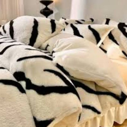 Zebra Print Faux Fur Blanket Set. Crafted with ultra-soft, high-density faux fur, this blanket brings a bold and exotic flair to your space with its striking black and white zebra pattern.