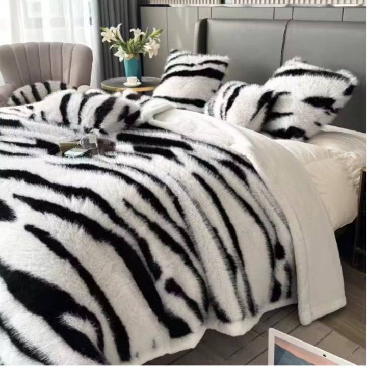 Zebra Print Faux Fur Blanket Set. Crafted with ultra-soft, high-density faux fur, this blanket brings a bold and exotic flair to your space with its striking black and white zebra pattern.