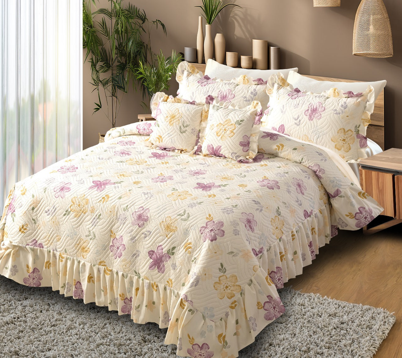 Floral bedspread set on a bed in a bedroom with plants and decor.