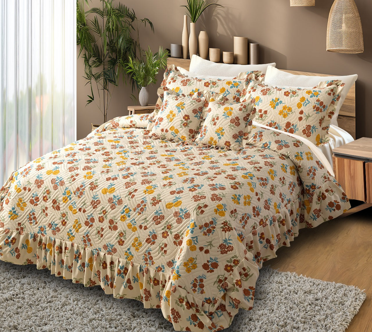 Floral patterned comforter set on a bed in a bedroom with plants and decor.