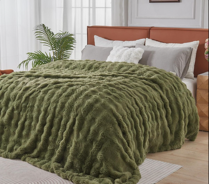 Green fuzzy blanket on a bed with a wooden headboard in a bedroom setting.