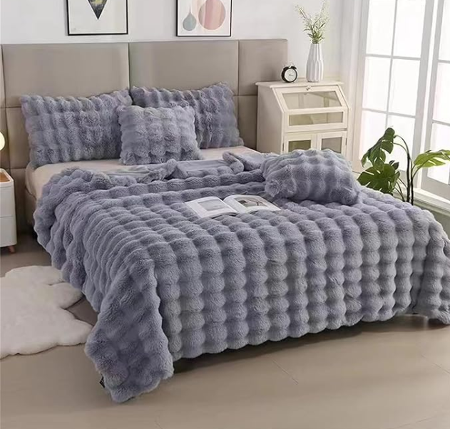 Gray textured comforter set on a bed in a bedroom setting