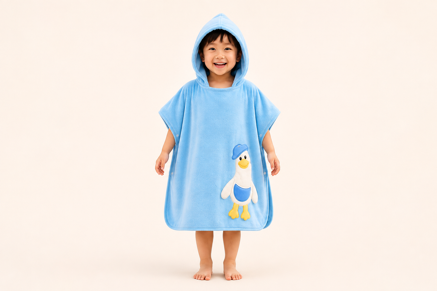 Blue hooded kids' bath poncho towel by The Gharnish with a playful duckie design, perfect for drying and cozying up after baths.
