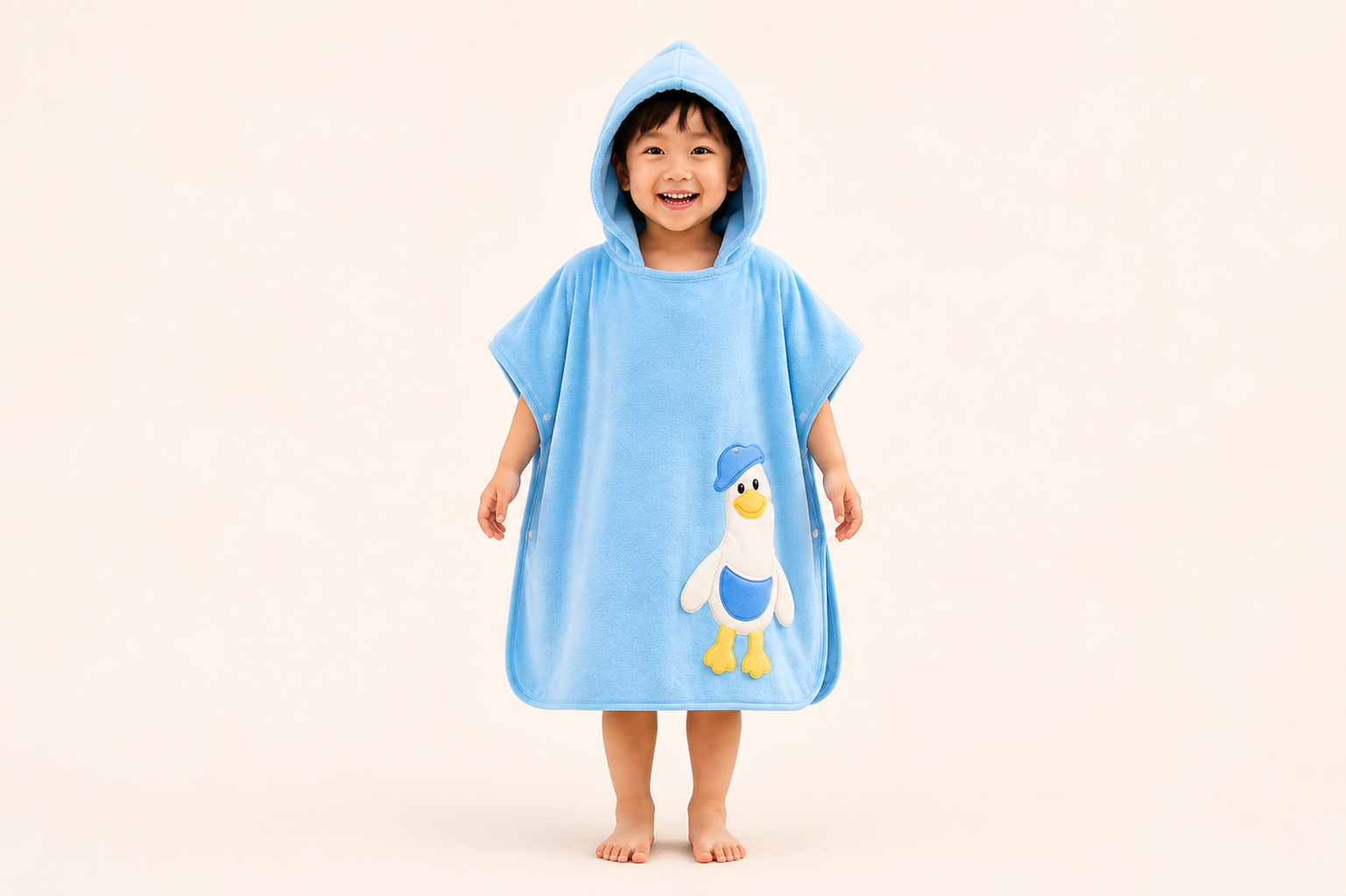 Blue hooded kids' bath poncho towel by The Gharnish with a playful duckie design, perfect for drying and cozying up after baths.