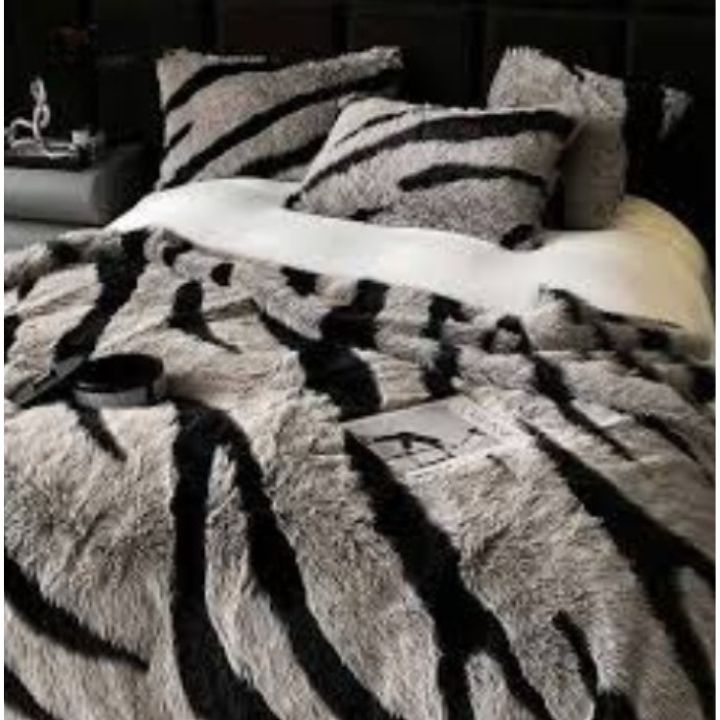 Zebra Print Faux Fur Blanket Set. Crafted with ultra-soft, high-density faux fur, this blanket brings a bold and exotic flair to your space with its striking black and white zebra pattern.
