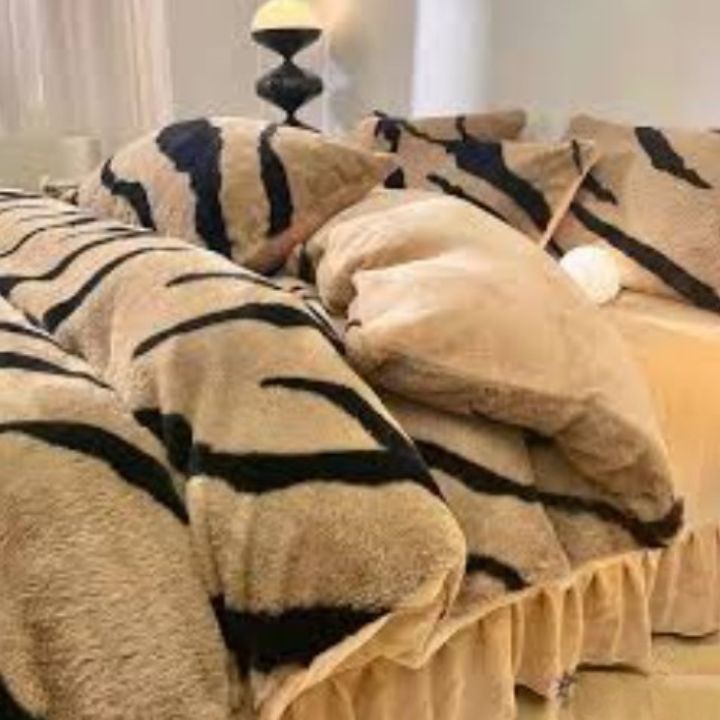 Zebra Print Faux Fur Blanket Set. Crafted with ultra-soft, high-density faux fur, this blanket brings a bold and exotic flair to your space with its striking black and white zebra pattern.