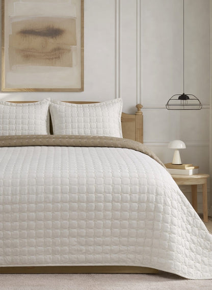 Soft and snug luxury 3-piece quilted bedding set by The Gharnish featuring a reversible pastel bedspread and matching pillow shams.