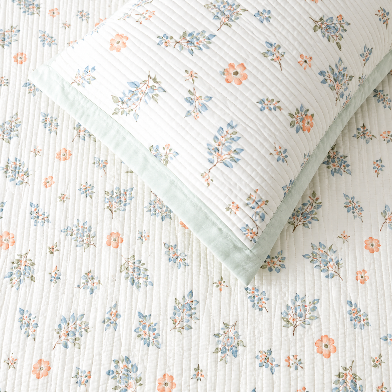 Soft floral bedding set of 3 from The Gharnish featuring a quilted bedcover and two matching pillow covers.