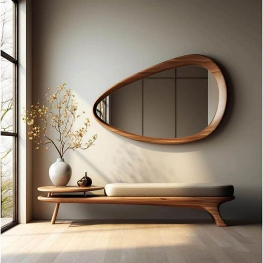 Modern interior with a wooden bench, round mirror, and decorative items.