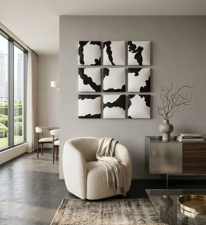 Modern living room with abstract wall art and a beige armchair.