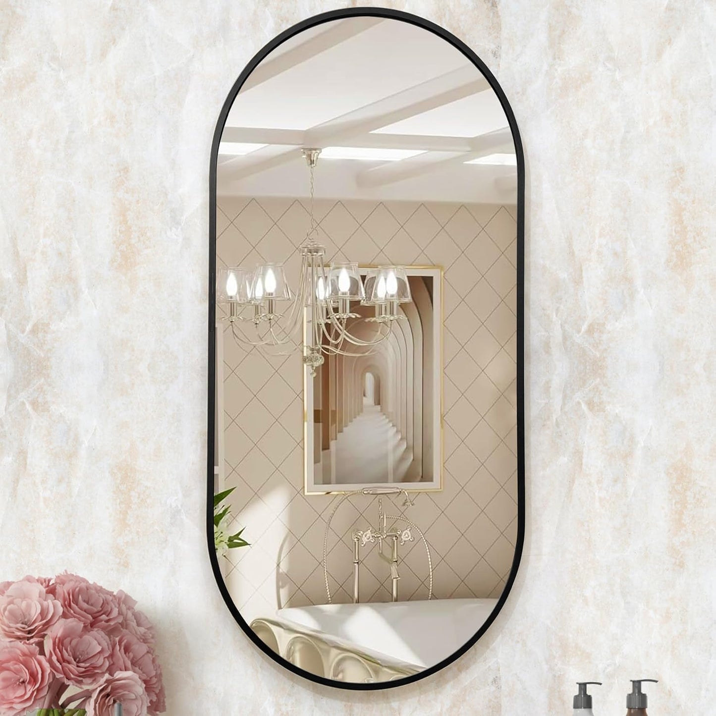 Oval mirror with black frame on a textured wall with floral decorations.