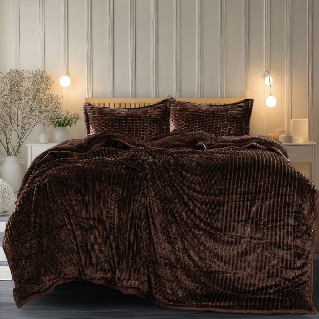 Brown textured comforter on a bed in a bedroom setting with striped wallpaper.