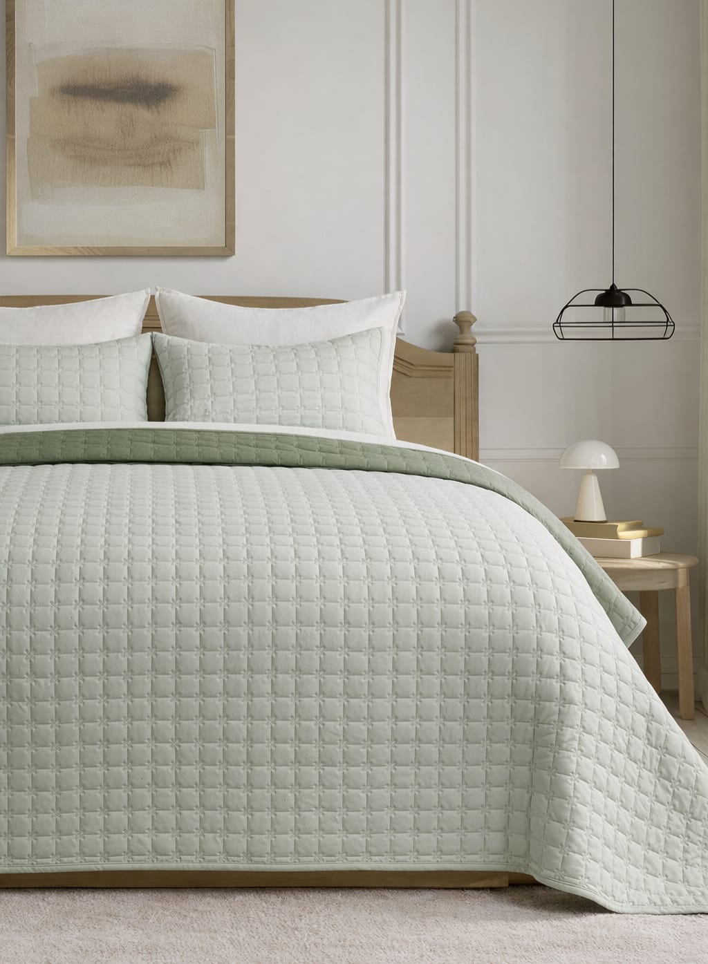 Soft and snug luxury 3-piece quilted bedding set by The Gharnish featuring a reversible pastel bedspread on a bed.