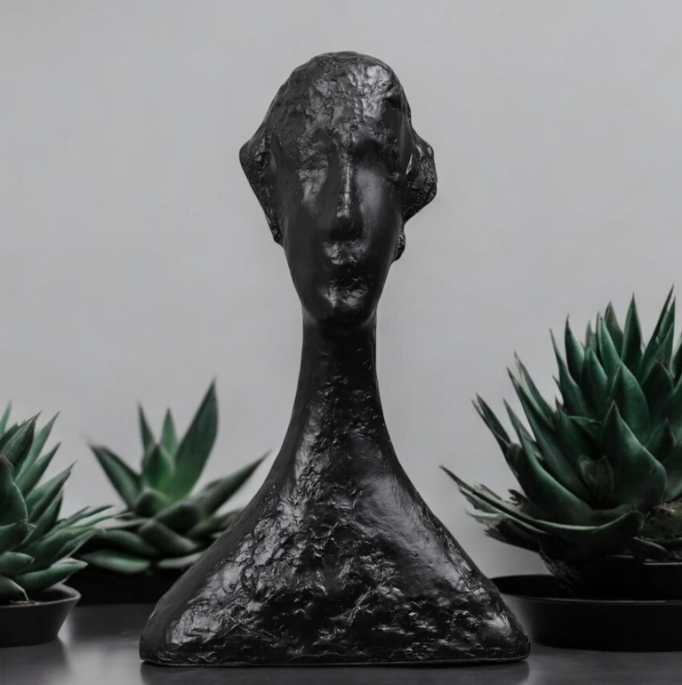Abstract artisan figurine by The Gharnish, contemporary sculpture with sleek, modern design and smooth finish.