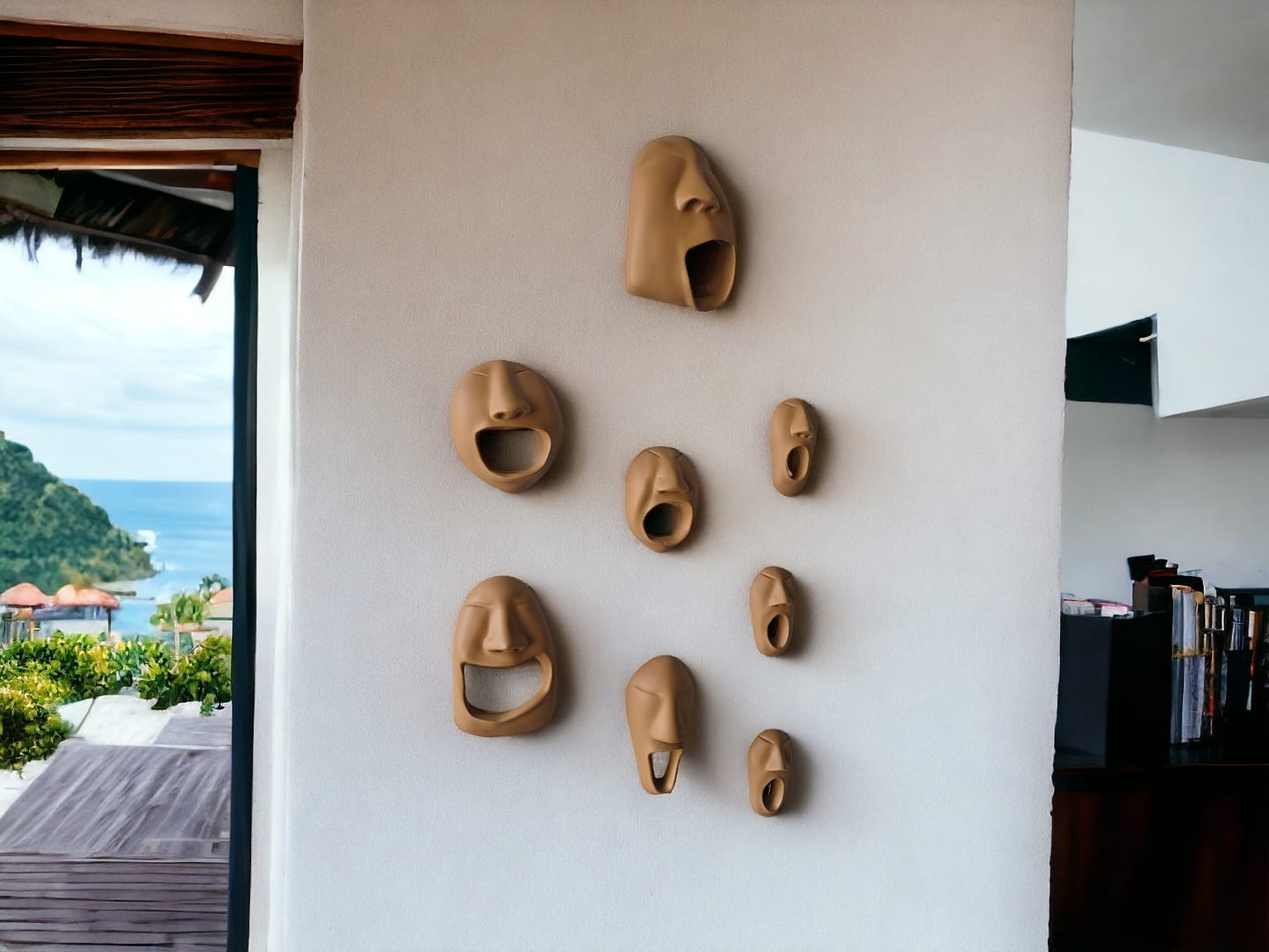 Set of ceramic face masks on a wall with a scenic view outside