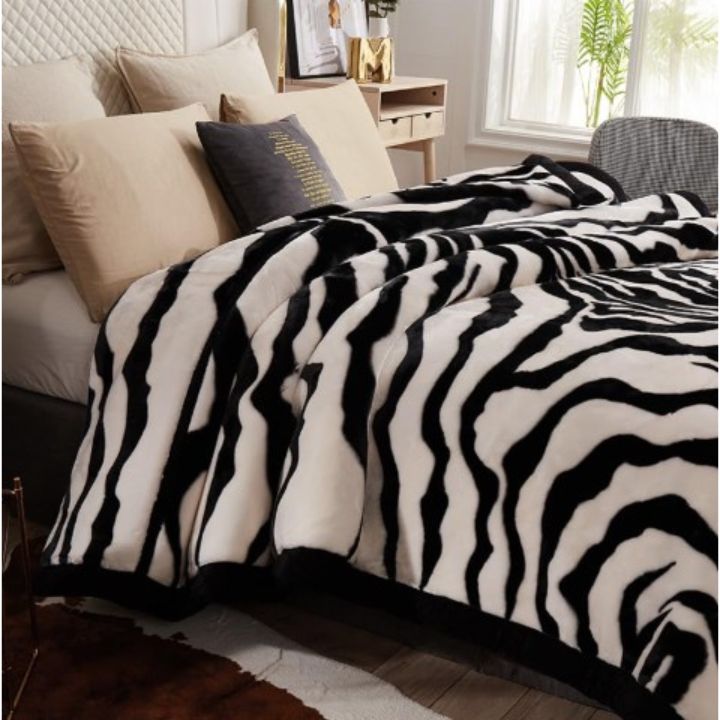 Zebra Print Faux Fur Blanket Set. Crafted with ultra-soft, high-density faux fur, this blanket brings a bold and exotic flair to your space with its striking black and white zebra pattern.