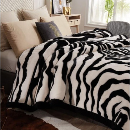 Zebra Print Faux Fur Blanket Set. Crafted with ultra-soft, high-density faux fur, this blanket brings a bold and exotic flair to your space with its striking black and white zebra pattern.
