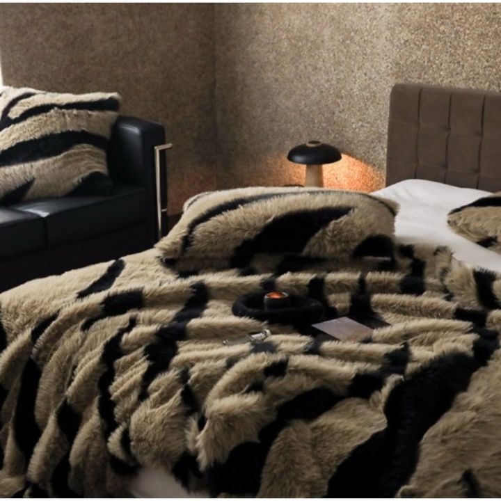 Zebra Print Faux Fur Blanket Set. Crafted with ultra-soft, high-density faux fur, this blanket brings a bold and exotic flair to your space with its striking black and white zebra pattern.