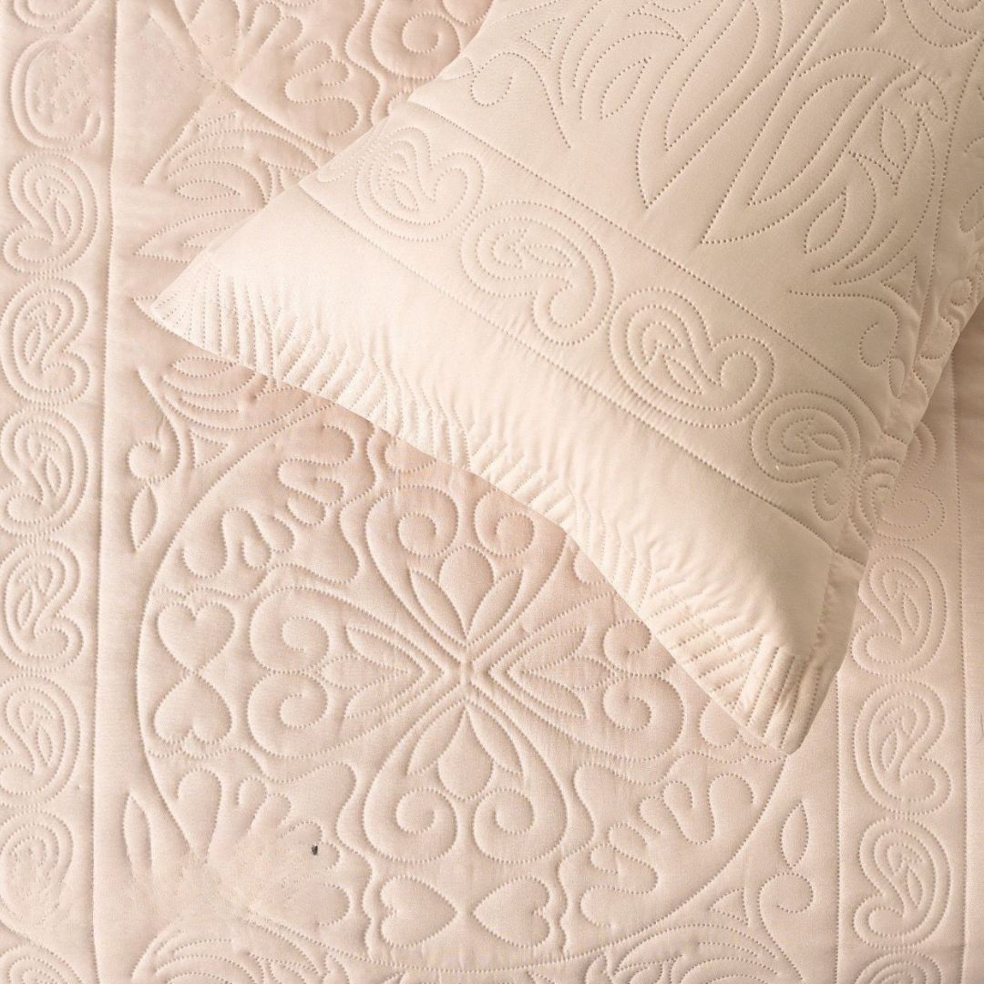 Close-up of a textured beige fabric with a patterned design