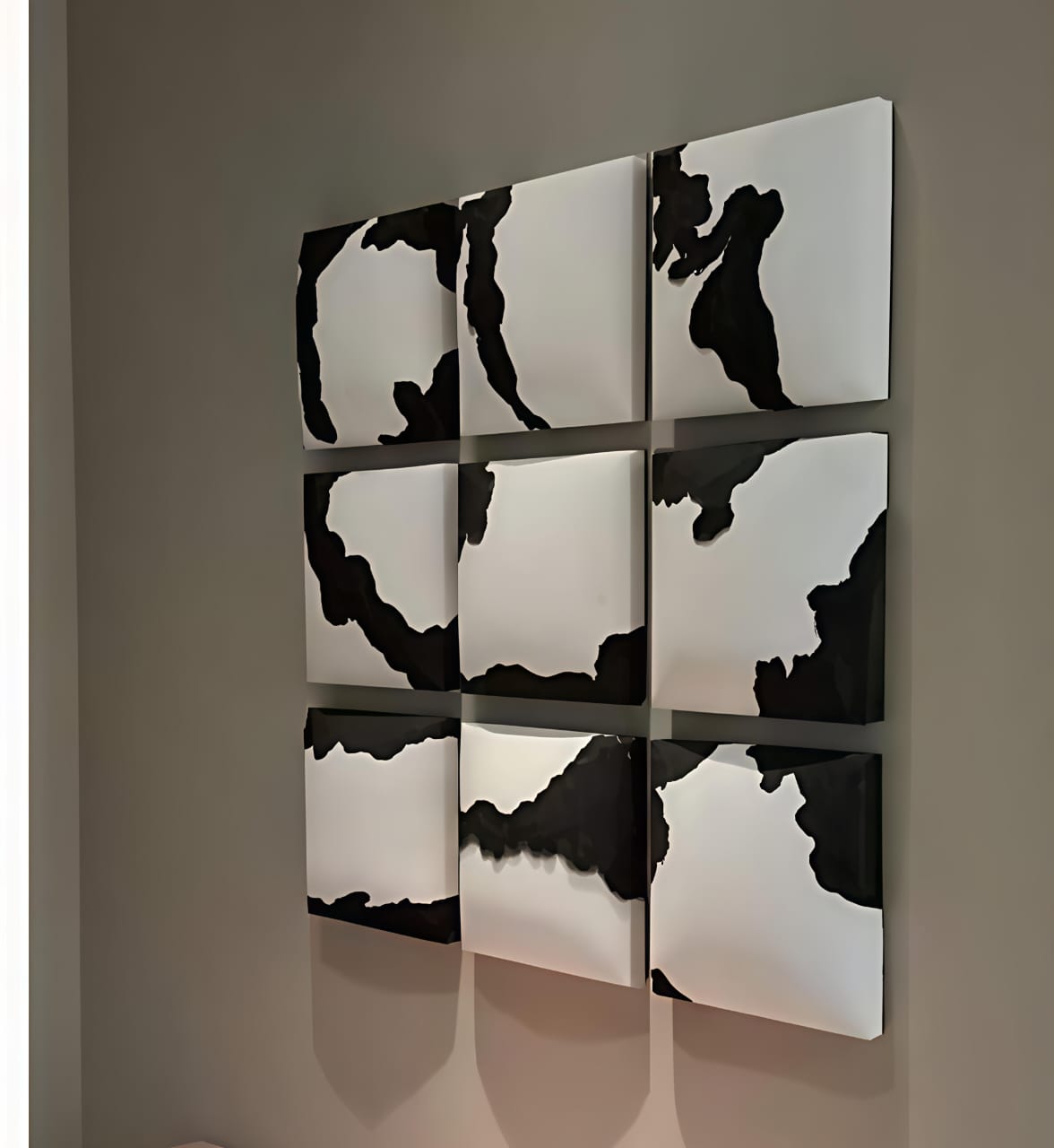 Wall art with black and white abstract patterns on a gray background