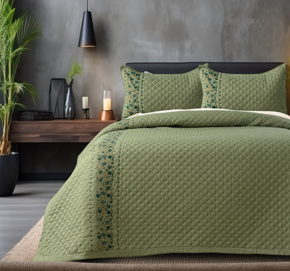 Blush Blossom quilted bedding set by The Gharnish featuring a floral pattern and soft pastel colors on a neatly made bed.
