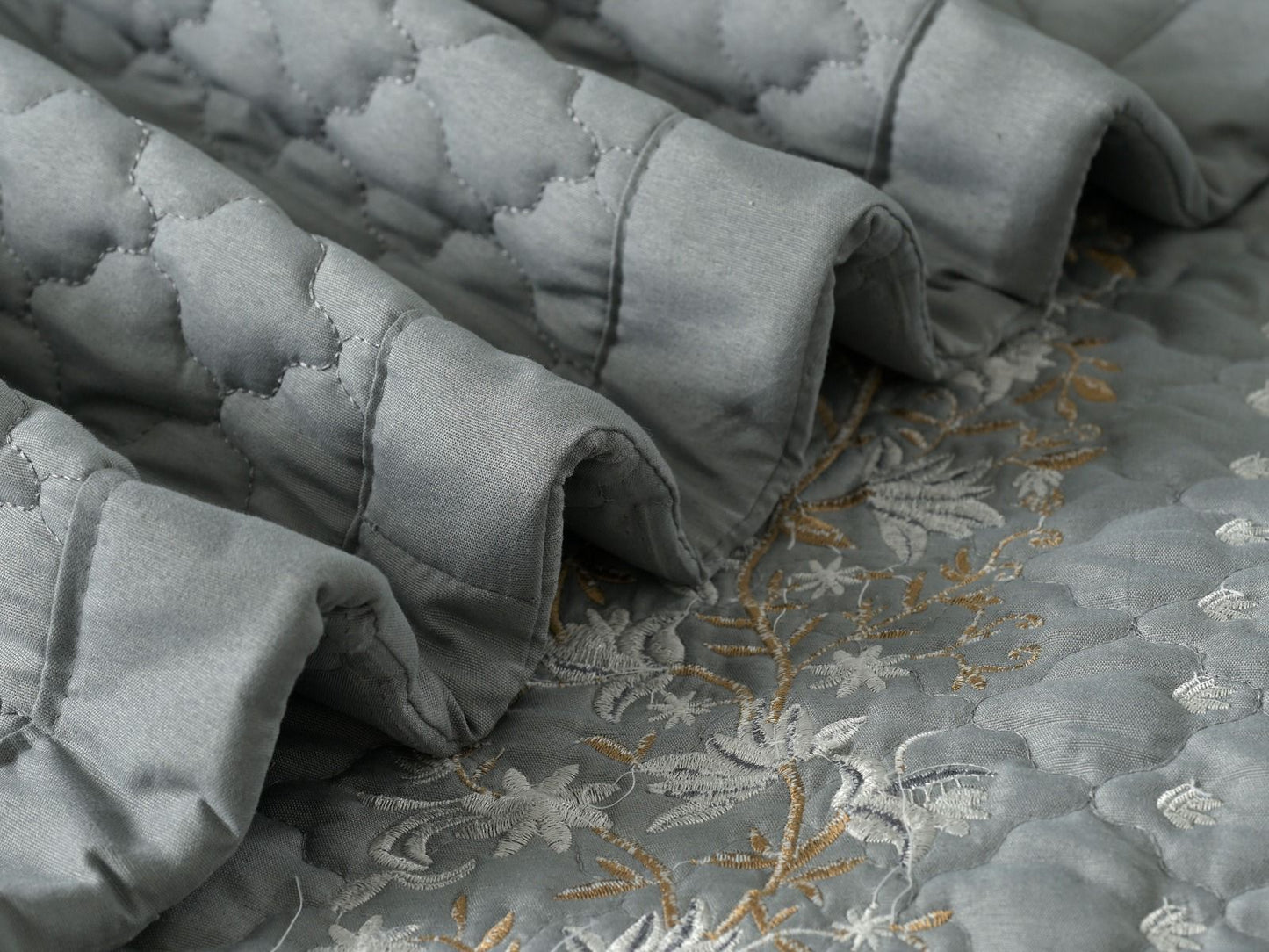 Blush Blossom quilted bedding set by The Gharnish, featuring a floral pattern and soft, comfortable fabric for a cozy bedroom look.