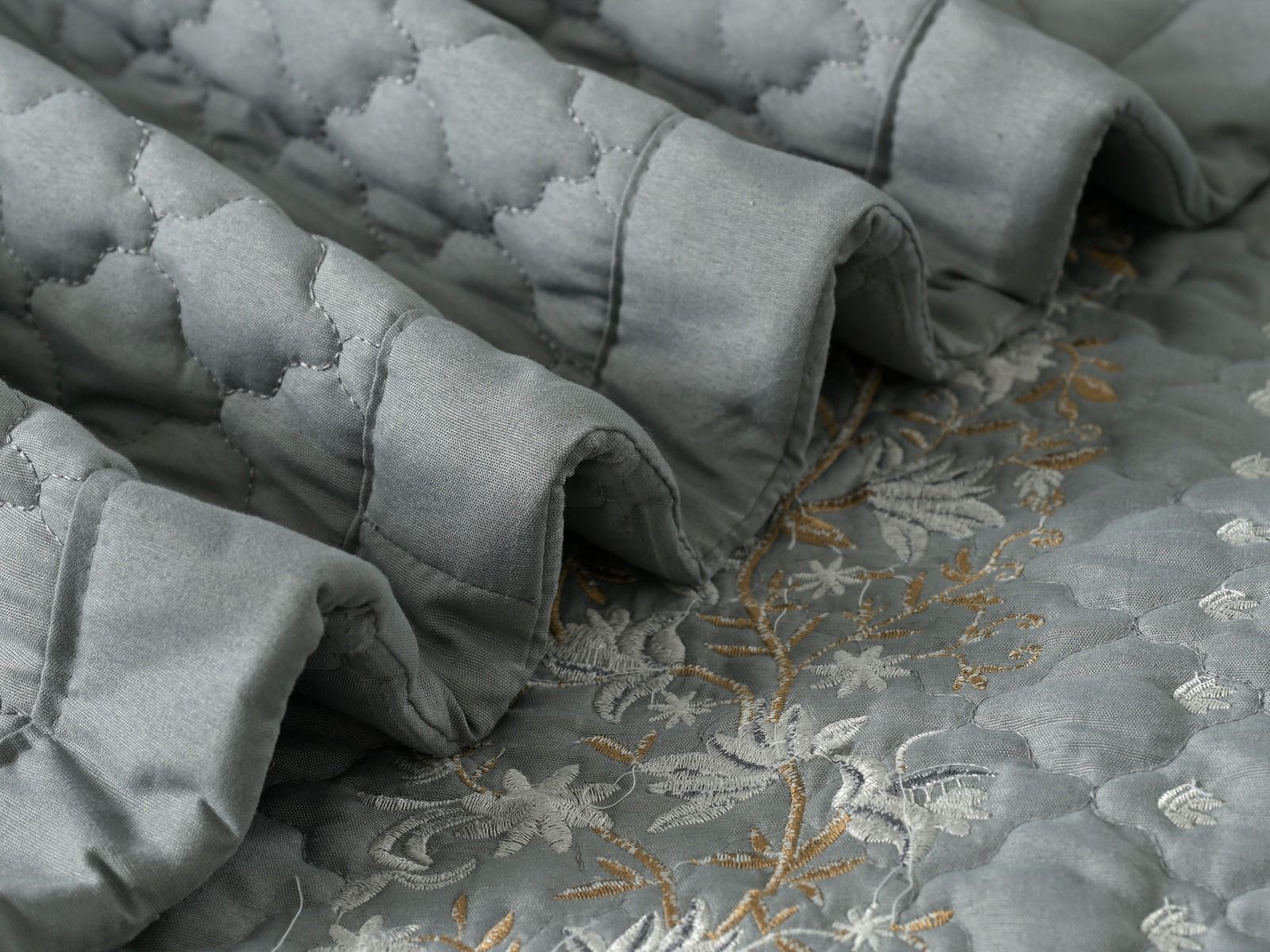 Blush Blossom quilted bedding set by The Gharnish, featuring a floral pattern and soft, comfortable fabric for a cozy bedroom look.