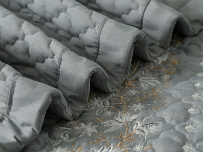 Blush Blossom quilted bedding set by The Gharnish, featuring a floral pattern and soft, comfortable fabric for a cozy bedroom look.