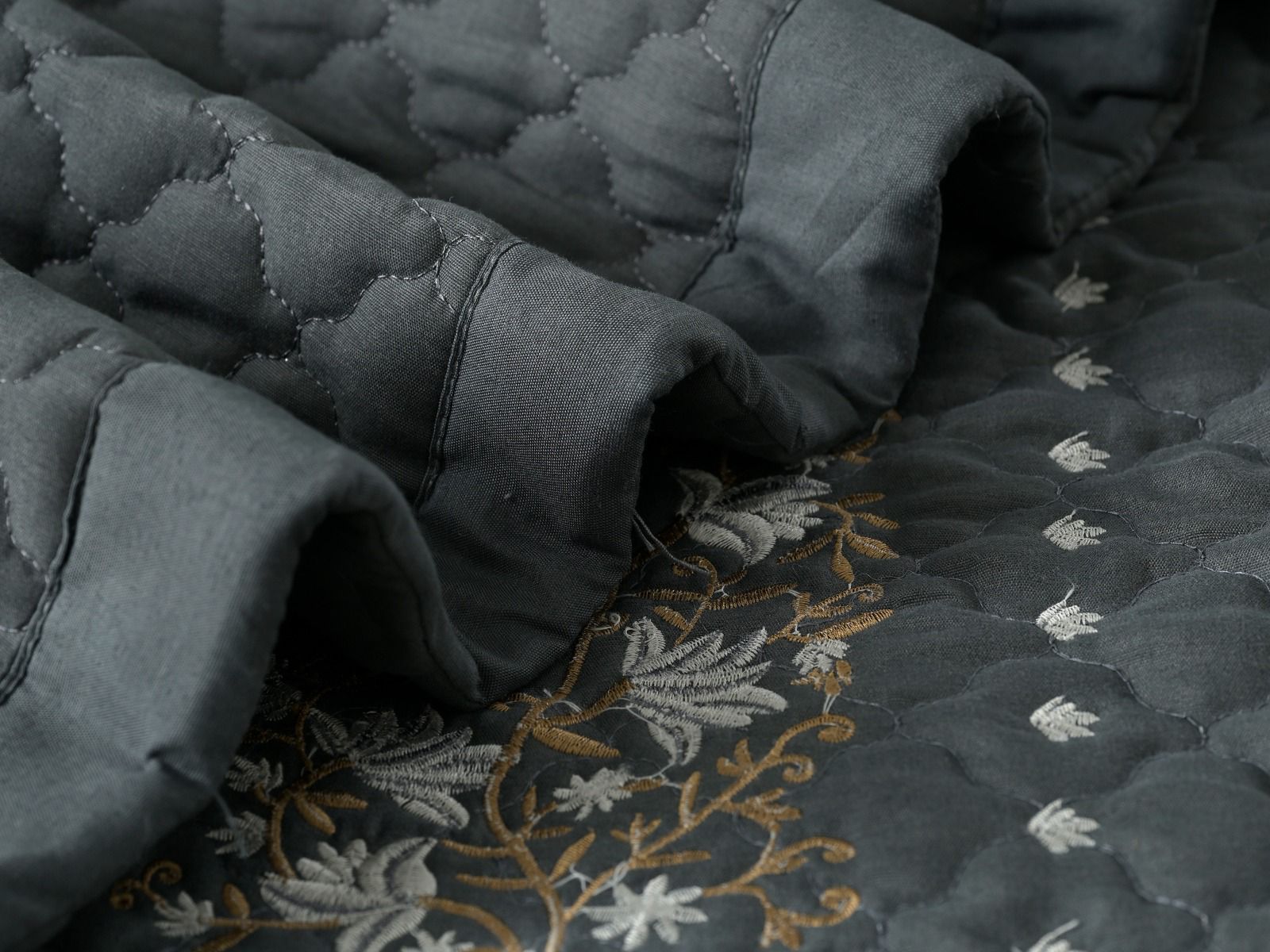 Blush Blossom quilted bedding set by The Gharnish featuring a floral pattern and soft, plush fabric for a cozy bedroom look.