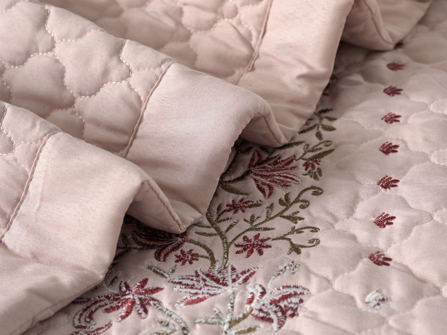 Blush Blossom quilted bedcover set by The Gharnish featuring a soft pink floral pattern on a cozy bedding set.