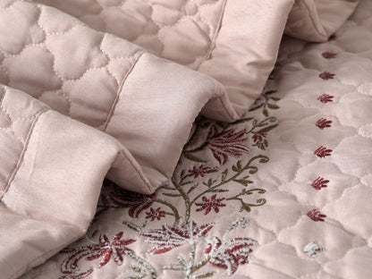 Blush Blossom quilted bedcover set by The Gharnish featuring a soft pink floral pattern on a cozy bedding set.