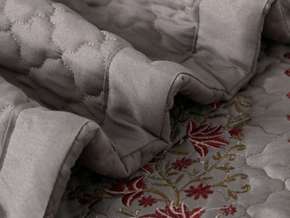 Blush Blossom quilted bedcover set by The Gharnish, featuring floral patterns and soft pastel colors for a cozy bedroom look.