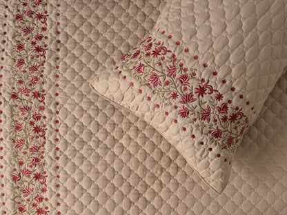 Blush Blossom quilted bedding set by The Gharnish featuring a soft, floral design perfect for a cozy bedroom decor.