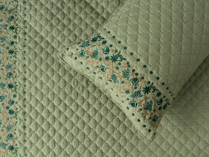 Blush Blossom quilted bedding set by The Gharnish featuring a soft pink floral pattern and cozy quilted texture.