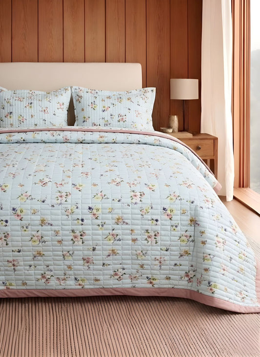 Luxury soft floral quilted bedcover with matching pillow covers from The Gharnish, featuring a elegant floral design and cozy bedding style.