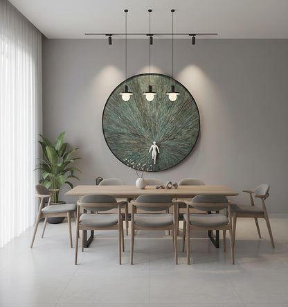 Modern dining room with a large round mirror on the wall, wooden table, and chairs.