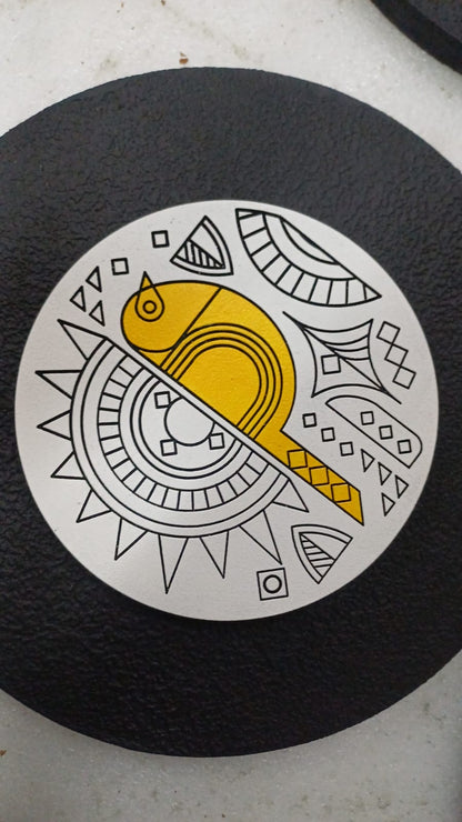 Circular design with a yellow fish and black geometric patterns on a black background